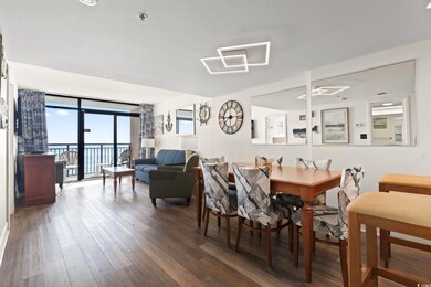 Dining space with dark hardwood / wood-style floor