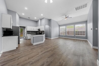 Kitchen featuring a ceiling fan, visible vents, d