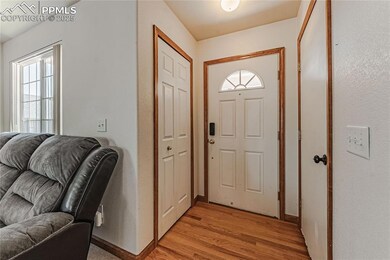 Entry with hardwood floors, coat close, door to ga