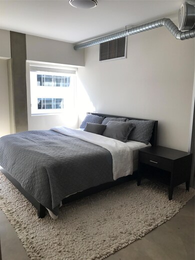Bedroom featuring finished concrete flooring and 
