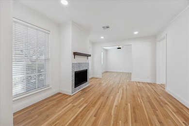 Upon entry and immediately to your left is the formal Living room w/ wood burning fireplace and mantle, recessed lighting and original and refinished White Oak hardwood floors.