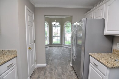 The kitchen also features new hardwood floor and a