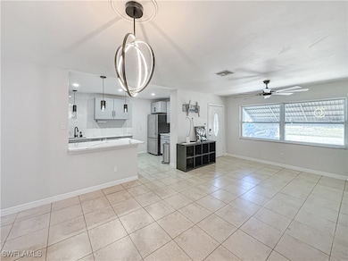 Kitchen with freestanding refrigerator, light coun