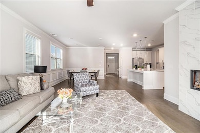 Living room with wainscoting, ornamental molding, 