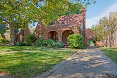 A winding sidewalk leads to the front porch.  The