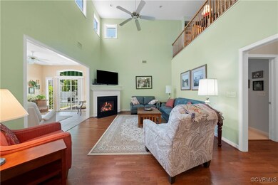 Living area featuring ceiling fan, a towering ceil