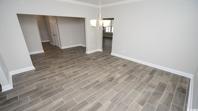 Unfurnished dining area featuring crown molding an