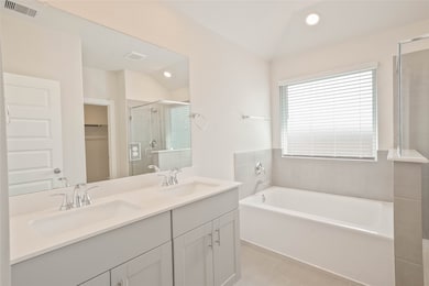 This modern bathroom features a double vanity with