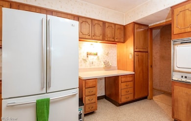 Kitchen featuring white fridge