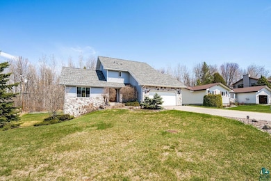 Traditional home with stone siding, concrete drive