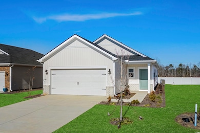 View of front facade with central AC, a garage, an