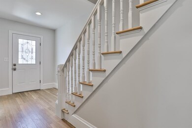 New door,hardwood floors,newly painted stairwell a