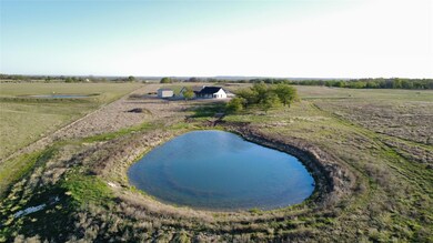 Drone / aerial view with a water view and a rural