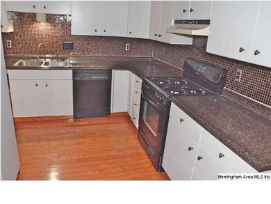 Gas range with smoked glass finish.