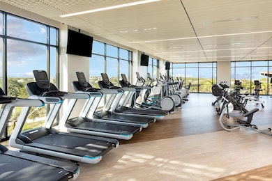 Gym featuring expansive windows and wood finished