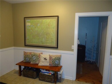 Large mudroom located between kitchen and garage t