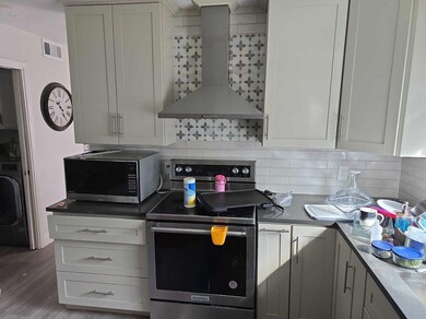 Kitchen with stainless steel appliances, visible v