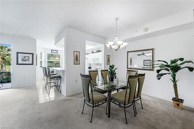 Carpeted dining area with an inviting chandelier