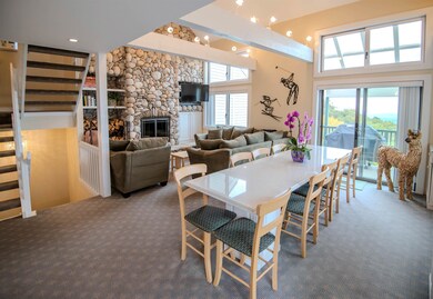 Open living space centered by woodburning fireplace