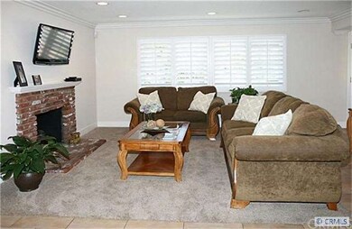 Formal living room includes brick fireplace with m