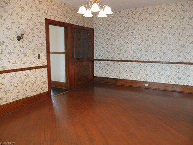 Spacious dining room with hardwood flooring, chair