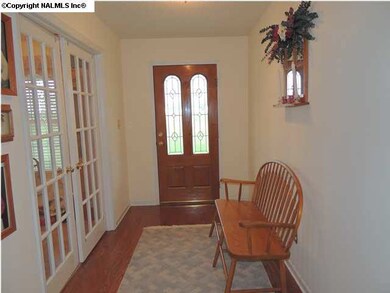 Welcome guests in the foyer complete with hardwood floors, lead glass front goor and glass french doors that open into formal dining room.