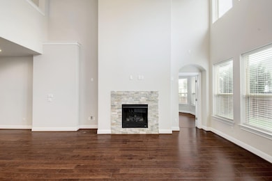 Unfurnished living room with a high ceiling, dark