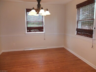 Formal dining room with hardwood floors and chair 