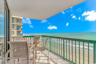 Balcony with view of water and beach
