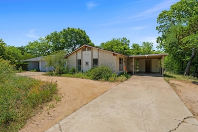 Mid-century home with concrete driveway, a carpor