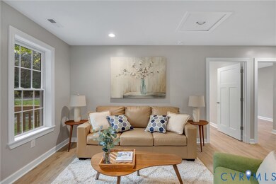 Living room with wood finished floors and recessed lighting