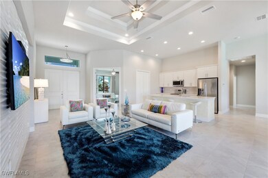 Living room featuring a high ceiling, ceiling fan,