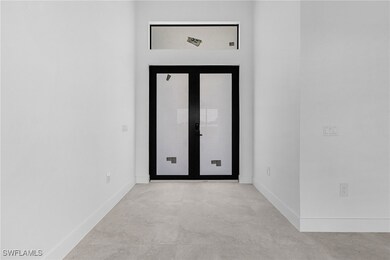 Spare room featuring concrete floors and baseboard