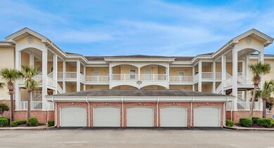 View of building exterior with community garages