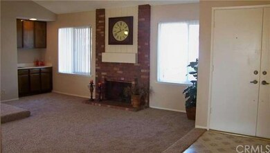Living Room With Brick Fireplace and Wet Bar