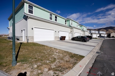 View of home's exterior featuring a mountain view, driveway, an attached garage, and a residential view