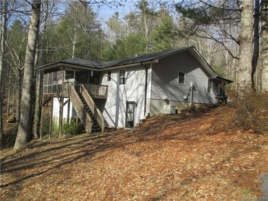 Rear of home showing deck, and outside basement en