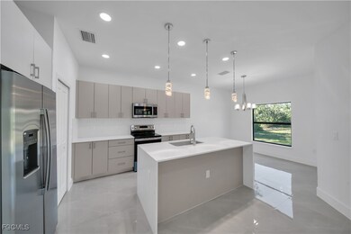 Kitchen with gray cabinets, stainless steel applia