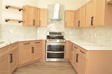 Kitchen with wall chimney exhaust hood, double ove