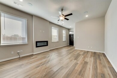 Unfurnished living room with a glass covered fireplace, recessed lighting, light wood finished floors, and ceiling fan