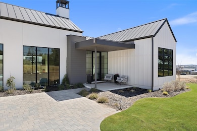 Property entrance with a standing seam roof, a me