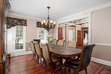 Formal dining room between foyer and kitchen with