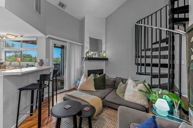Living room with wood finished floors, a brick fi