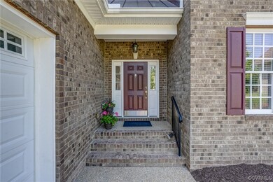 A brick porch creates an elegant entry and the sid