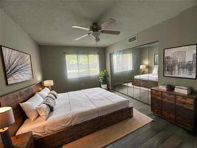 Spacious Primary Bedroom with Mirror Closet Doors for visual double the space
