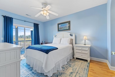Bedroom featuring a ceiling fan, baseboards, visib
