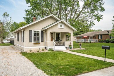 Welcoming front porch with room for chairs and a s