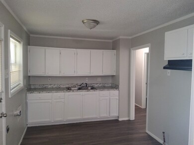 Kitchen featuring crown molding, a textured ceilin
