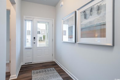 Doorway to outside featuring dark wood finished fl