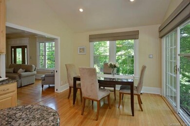 DINING AREA LOOKS OUT ON GARDENS THAT SURROUND THI